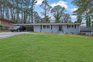 Ranch-style home featuring a front lawn, a carport