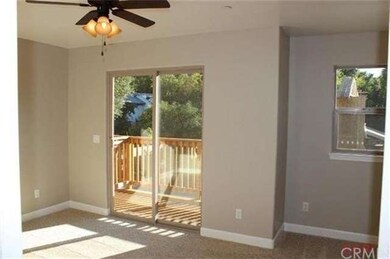 Master bedroom with ceiling fan and sliding door t