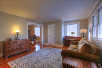 The living room has lots of windows, a powder room