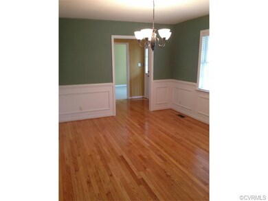 Formal Dining Room with wood floors and picture mo