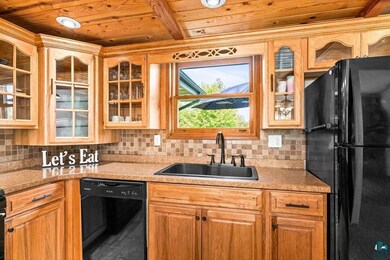 Kitchen with decorative backsplash, black applianc