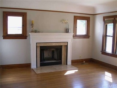 Living room, wood burning fire place, oak floors.