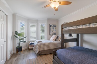Bedroom with wood finished floors, baseboards, cr
