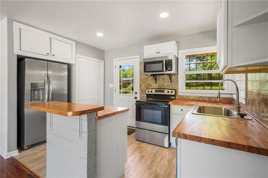 Kitchen with butcher block counters, appliances wi