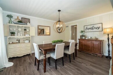 Spacious Dining Room with Laminate Wood Flooring w