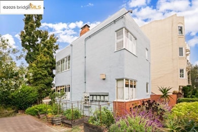 Rear view of property featuring stucco siding, a garden, brick siding, and a chimney