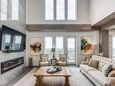Living area with 20 ft ceiling opens to balcony