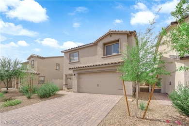 featuring stucco siding, a tiled roof, an attached garage, and decorative driveway