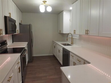 Kitchen with dark hardwood / wood-style flooring, 