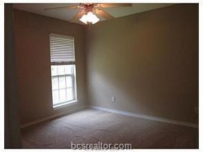 Unfurnished room with ceiling fan, baseboards, and