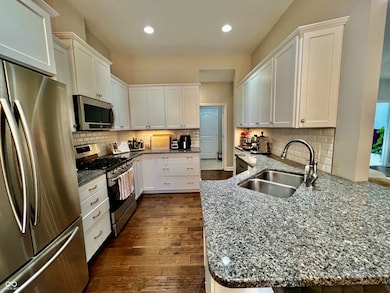 Kitchen with tile back splash and granite counter tops