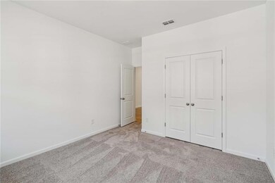 Unfurnished bedroom featuring light colored carpet and a closet