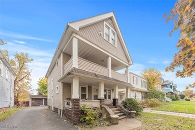 View of front of home with an outdoor structure, covered porch, and a garage