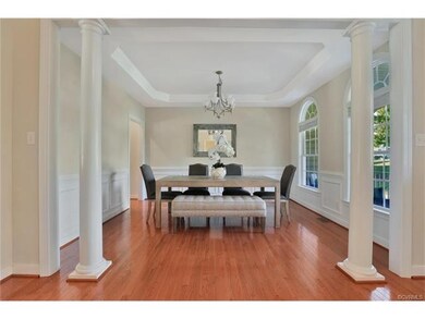 Dining Room - 11 x 13, hardwood floor, chandelier, tray ceiling, multiple-member crown moulding, picture-frame moulding, chair rail moulding
