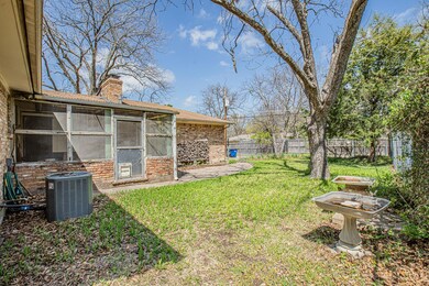 View of yard featuring a sunroom, central AC, and 