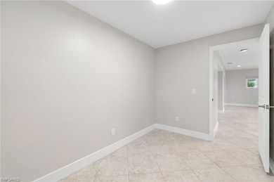 Unfurnished room featuring light tile patterned fl