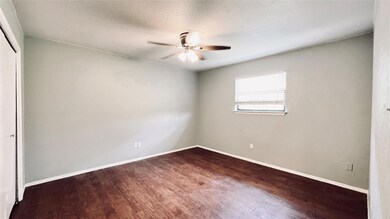 Spare room with baseboards, ceiling fan, and wood