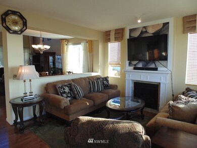 Family room with Gas Fireplace and Large pass through to the dining room and living room. Open Concept.