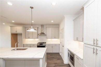 Quartz cabinets, SS appliances, refrigerator not included, under cabinet lighting - Pictures represent a previously built home, not the actual home.