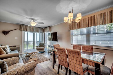 Dining area with an AC wall unit, ornamental molding, ceiling fan with notable chandelier, and light wood-type flooring