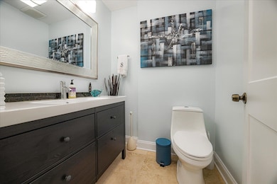 Bathroom with vanity and baseboards