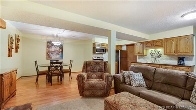 Living, dining and kitchen.  Laminate floors are p