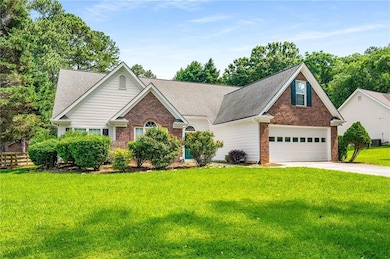 View of front of home featuring brick siding, concrete driveway, and roof with shingles