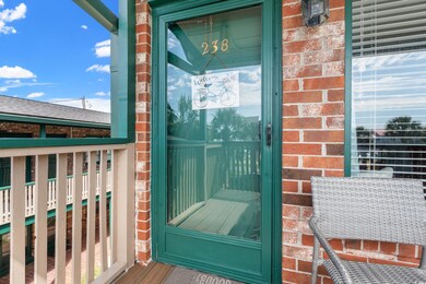 View of exterior entry with a balcony