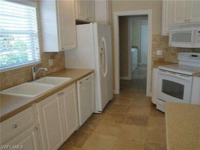 Bright kitchen with custom backsplash and Corian c