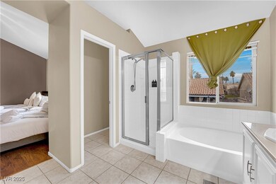 Ensuite bathroom featuring tile patterned floors,