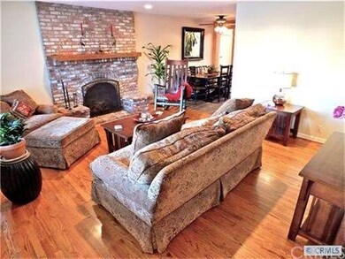 Gorgeous hardwood floors and used brick fireplace 