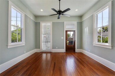 Front living room with floor to ceiling window.