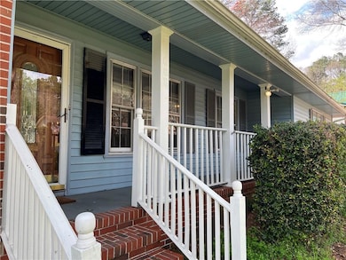 Doorway to property featuring a porch