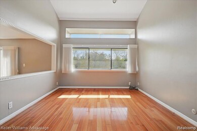 Spare room with baseboards and wood finished floors