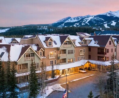 Snow covered house featuring a mountain view
