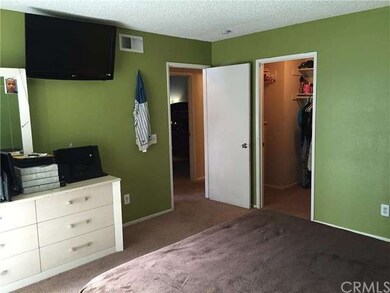 Master bedroom has a walk in closet and sliding do