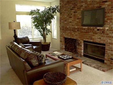 Large family room with huge brick fireplace. Direc