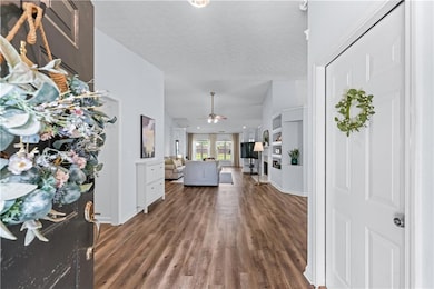 Entryway featuring vaulted ceiling, wood finished 