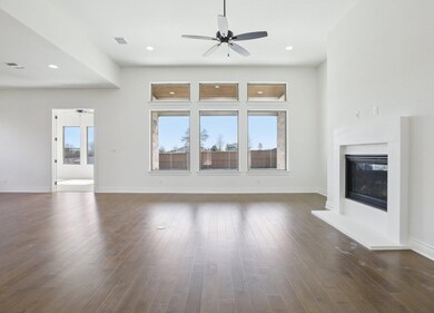 Unfurnished living room featuring a ceiling fan, 