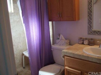 Attached bathroom off master. Behind the purple cu