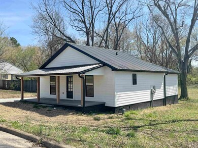 View of property exterior featuring fence, metal r