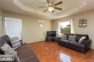 This inviting living room boasts ample natural light, a recessed ceiling and comfortable seating arrangements, making it ideal for relaxing or hosting guests. Imagine unwinding here after a long day or enjoying a cozy family movie night. Picture yourself creating memories in a space that's perfectly designed for comfort and connection.