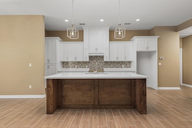The modern kitchen, open to the great room, showca