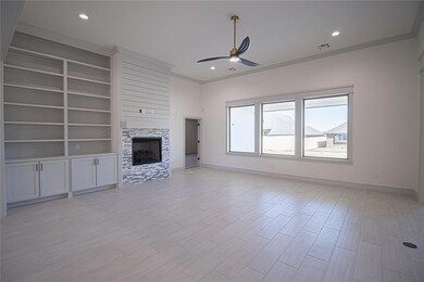 Unfurnished living room with ceiling fan, built in