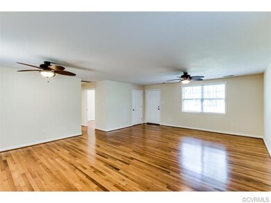 The living room features two windows, which overlo