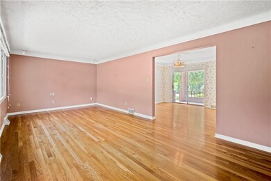 The large 23x11ft living room has original oak har