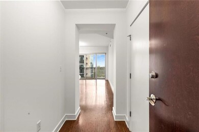 Corridor with wood finished floors and baseboards