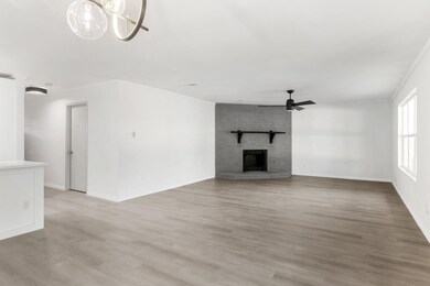 Unfurnished living room featuring baseboards, a b