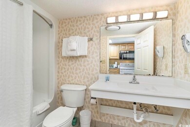 Bathroom with toilet, sink, and a textured ceiling