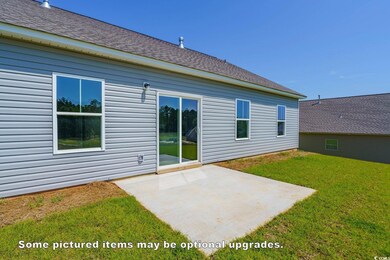 Back of house with a patio area and a lawn